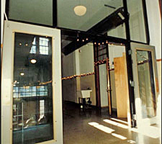 Glass partition in a former school stair hall