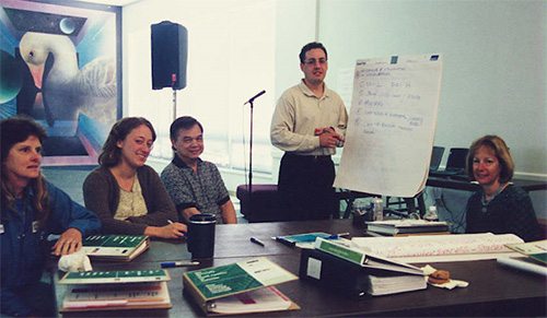 Charrette work group participants work with the facilitator to capture ideas on flip chart.